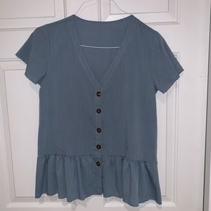 V-neck ruffle hemmed blouse with button front